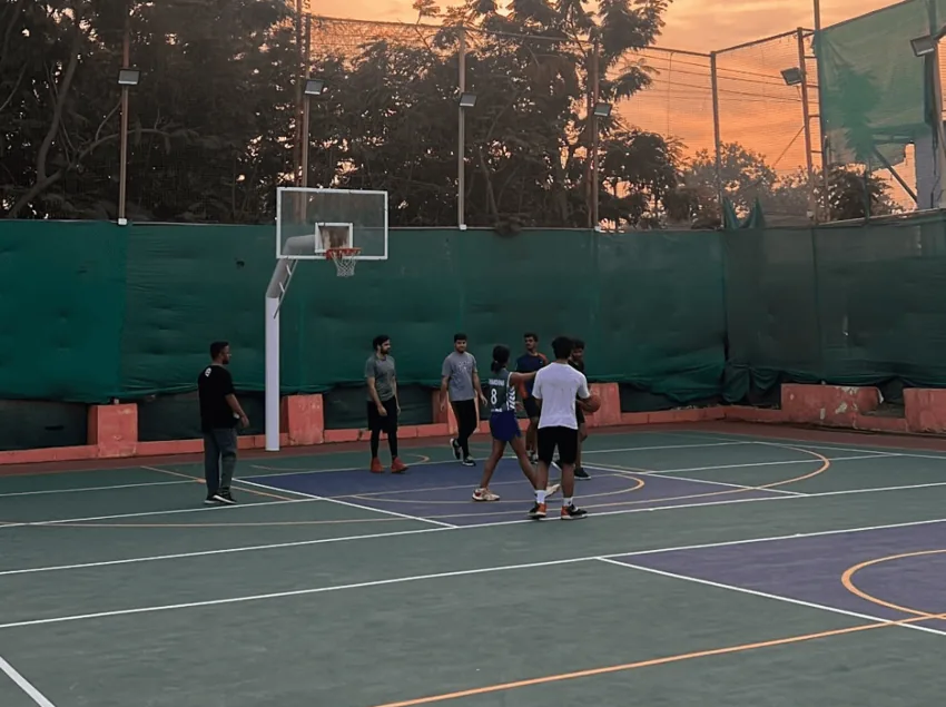 Friends playing basketball outdoors
